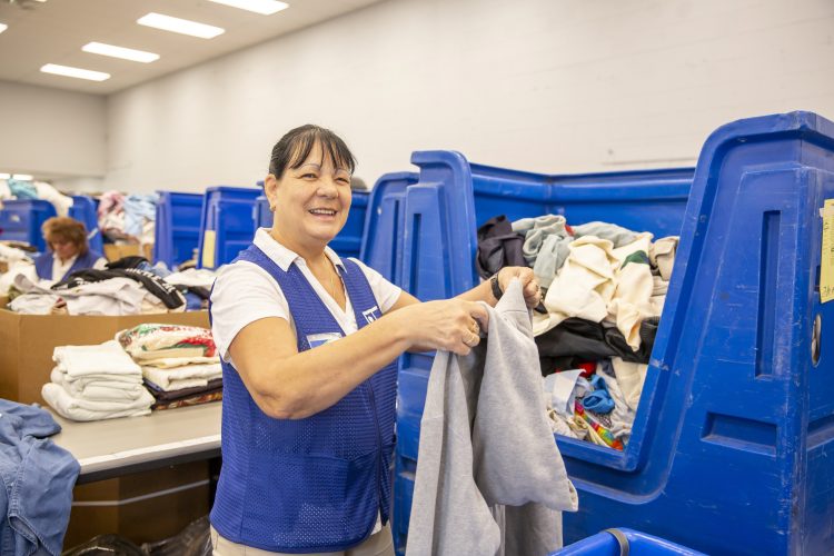 Goodwill Manasota team members sorting donations at the Waterside ADC in Lakewood Ranch.