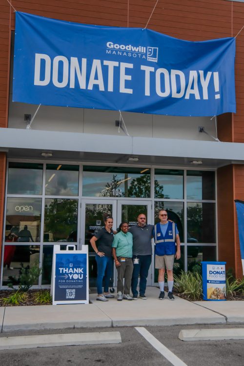 Goodwill Manasota Waterside ADC operations team posing in front of the storefront on opening day in Lakewood Ranch.